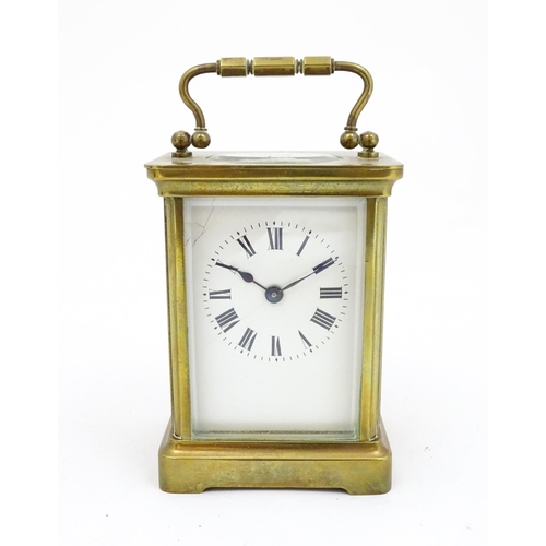 1301 - A brass carriage clock with French movement by Duverdry & Bloquel, the white enamel dial with Roman ... 