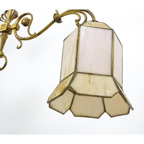 1310 - A 20thC twin pendant rise and fall ceiling lamp of scrolling form with twin shades. Approx 25