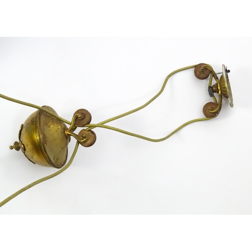 1310 - A 20thC twin pendant rise and fall ceiling lamp of scrolling form with twin shades. Approx 25