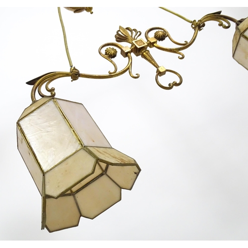 1310 - A 20thC twin pendant rise and fall ceiling lamp of scrolling form with twin shades. Approx 25