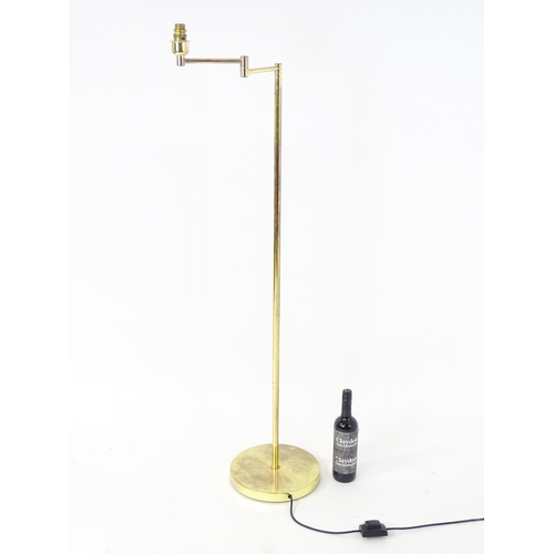 1316 - A brass standard lamp with adjustable arm. Approx 54