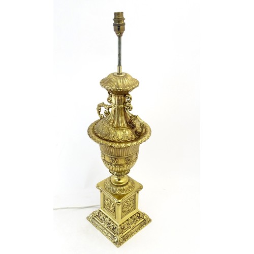 1320 - A gilt metal table lamp of twin handled urn form. Approx. 28