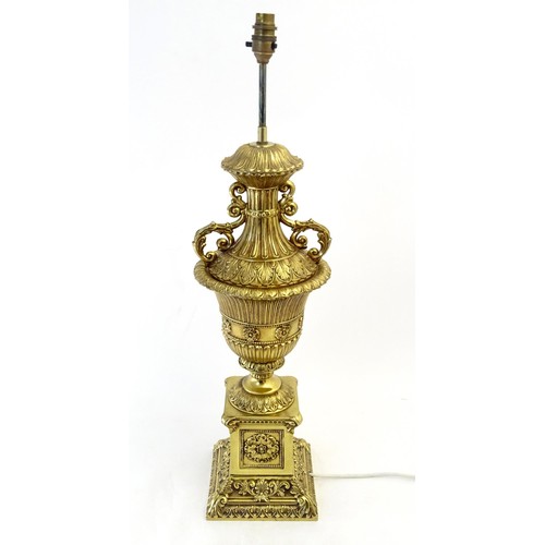 1320 - A gilt metal table lamp of twin handled urn form. Approx. 28