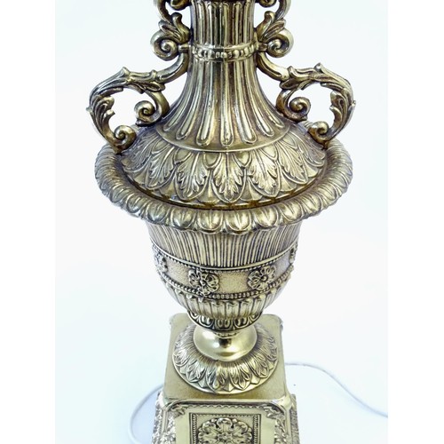 1320 - A gilt metal table lamp of twin handled urn form. Approx. 28