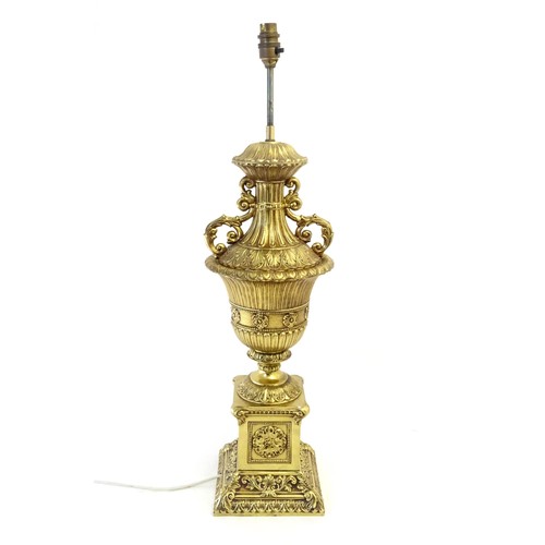 1320 - A gilt metal table lamp of twin handled urn form. Approx. 28