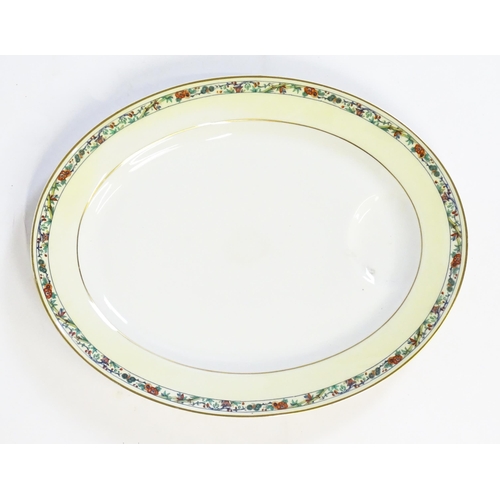 171 - A quantity of Haviland Limoges dinner wares with banded foliate border, to include plates, serving p... 