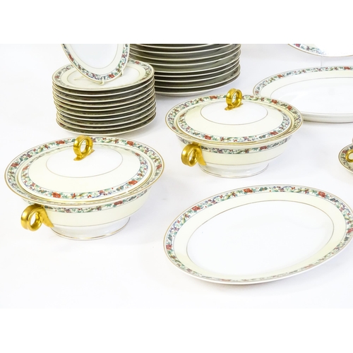 171 - A quantity of Haviland Limoges dinner wares with banded foliate border, to include plates, serving p... 