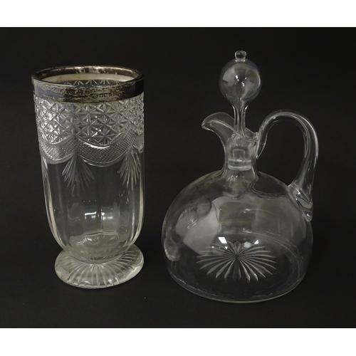 241 - A 19thC whisky water jug and stopper. Together with a 19thC cut glass vase with silver rim, hallmark... 