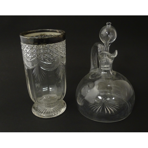 241 - A 19thC whisky water jug and stopper. Together with a 19thC cut glass vase with silver rim, hallmark... 