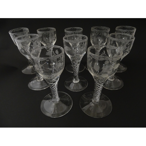 244 - Ten Georgian drinking glasses with air twist detail to stems, the bowls engraved with floral and fol... 