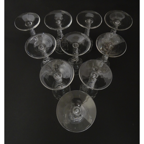 244 - Ten Georgian drinking glasses with air twist detail to stems, the bowls engraved with floral and fol... 