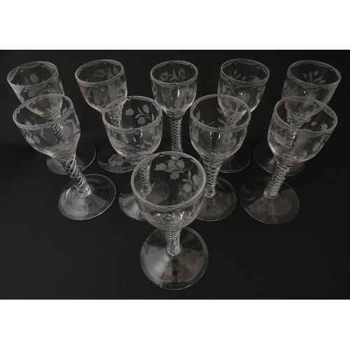 244 - Ten Georgian drinking glasses with air twist detail to stems, the bowls engraved with floral and fol... 