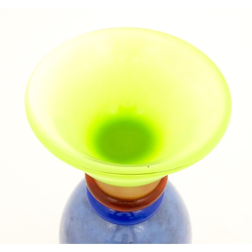 249 - Dan Aston : A large studio glass vase worked in red, blue, lime green and purple glass by Dan Aston.... 