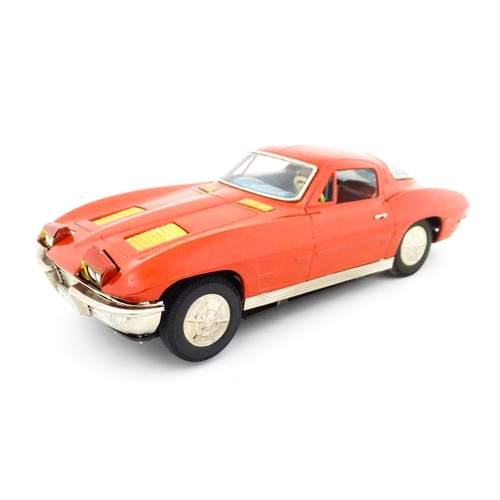 825 - Toy: A 20thC boxed Ichida scale model tinplate battery powered red Chevrolet Corvette Sting Ray Spor... 