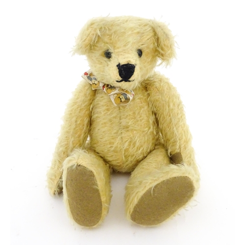 826 - Toy: A 20thC mohair teddy bear with stitched nose and mouth, pad paws, and articulated head and limb... 