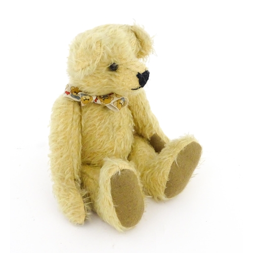 826 - Toy: A 20thC mohair teddy bear with stitched nose and mouth, pad paws, and articulated head and limb... 