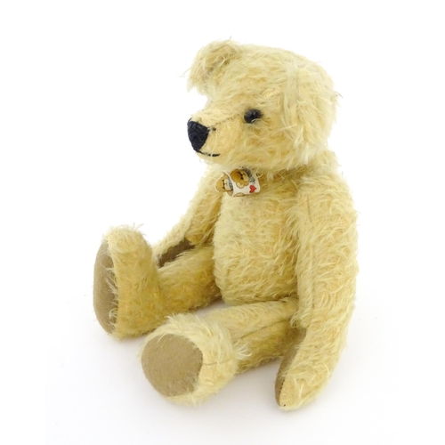 826 - Toy: A 20thC mohair teddy bear with stitched nose and mouth, pad paws, and articulated head and limb... 