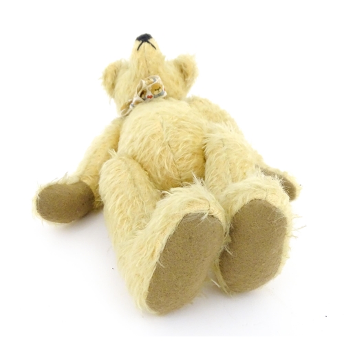 826 - Toy: A 20thC mohair teddy bear with stitched nose and mouth, pad paws, and articulated head and limb... 