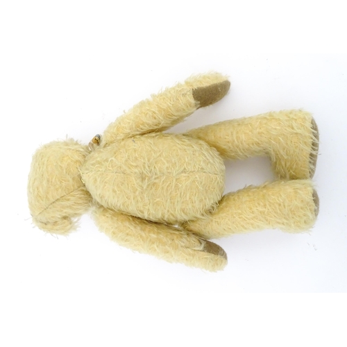 826 - Toy: A 20thC mohair teddy bear with stitched nose and mouth, pad paws, and articulated head and limb... 