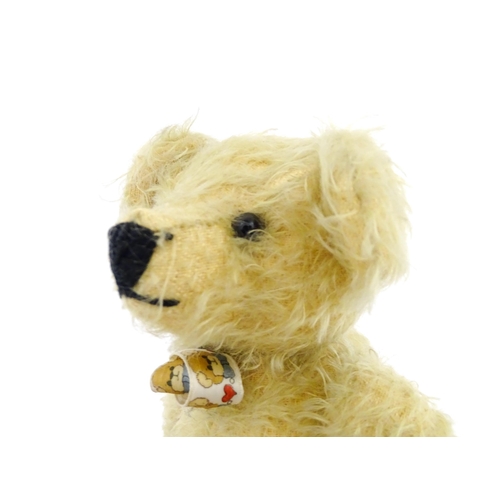 826 - Toy: A 20thC mohair teddy bear with stitched nose and mouth, pad paws, and articulated head and limb... 