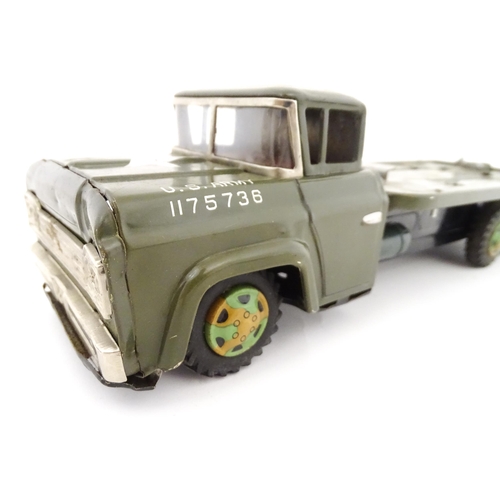 827 - A 20thC boxed scale model tinplate friction powered Army Tank Carrier and Camouflaged Tank. Made in ... 