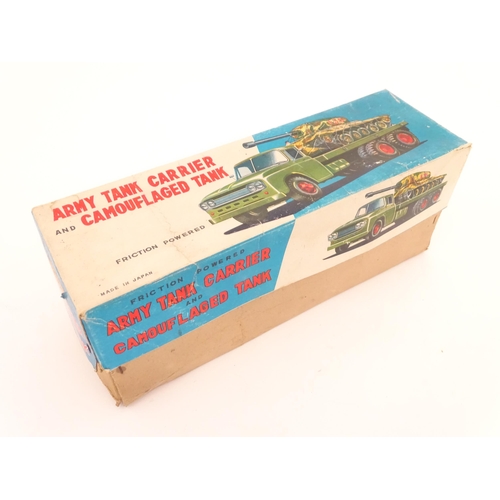 827 - A 20thC boxed scale model tinplate friction powered Army Tank Carrier and Camouflaged Tank. Made in ... 