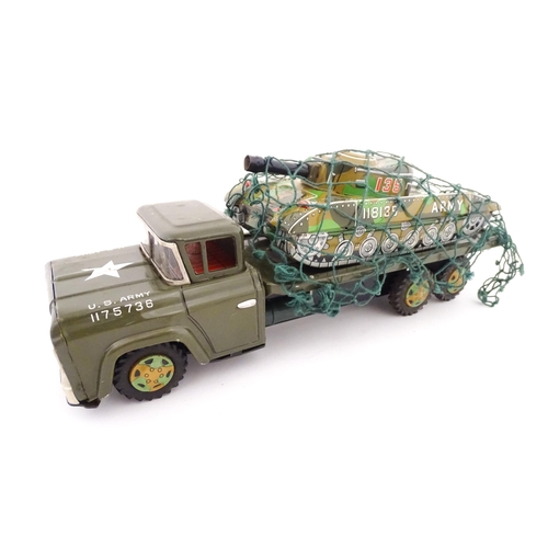 827 - A 20thC boxed scale model tinplate friction powered Army Tank Carrier and Camouflaged Tank. Made in ... 