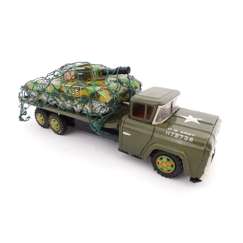 827 - A 20thC boxed scale model tinplate friction powered Army Tank Carrier and Camouflaged Tank. Made in ... 