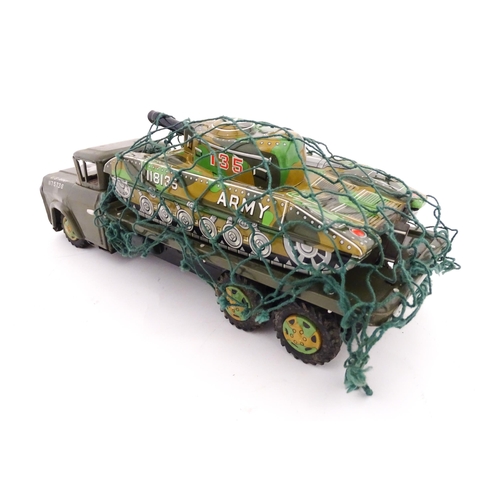 827 - A 20thC boxed scale model tinplate friction powered Army Tank Carrier and Camouflaged Tank. Made in ... 