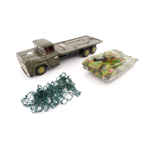 827 - A 20thC boxed scale model tinplate friction powered Army Tank Carrier and Camouflaged Tank. Made in ... 