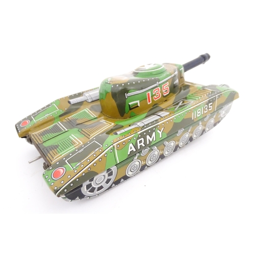 827 - A 20thC boxed scale model tinplate friction powered Army Tank Carrier and Camouflaged Tank. Made in ... 