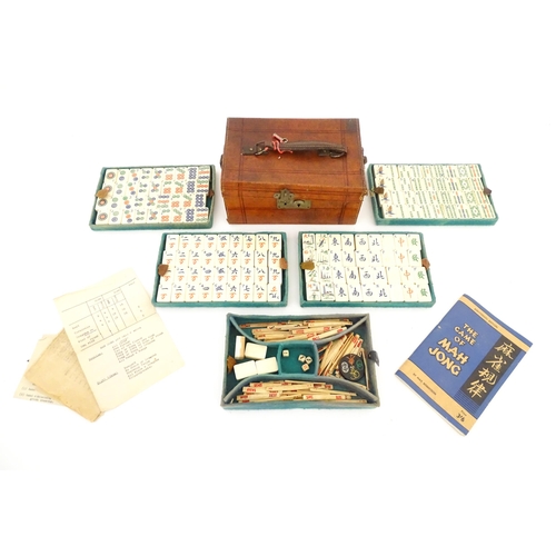 833 - Toys: A 20thC Chinese bone and bamboo Mahjong set within a leather case with five lift out trays. To... 