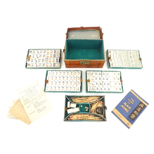 833 - Toys: A 20thC Chinese bone and bamboo Mahjong set within a leather case with five lift out trays. To... 