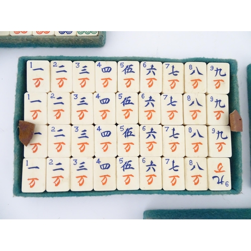 833 - Toys: A 20thC Chinese bone and bamboo Mahjong set within a leather case with five lift out trays. To... 