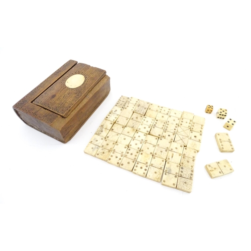 835 - Toys: A quantity of 19thC prisoner of war carved bone dominoes within a wooden box of book form. Dom... 