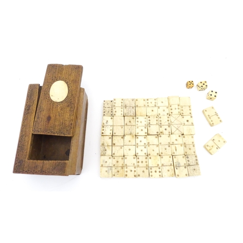 835 - Toys: A quantity of 19thC prisoner of war carved bone dominoes within a wooden box of book form. Dom... 