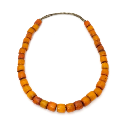 699 - A vintage bead necklace of graduated amber coloured cylindrical beads. Approx. 30