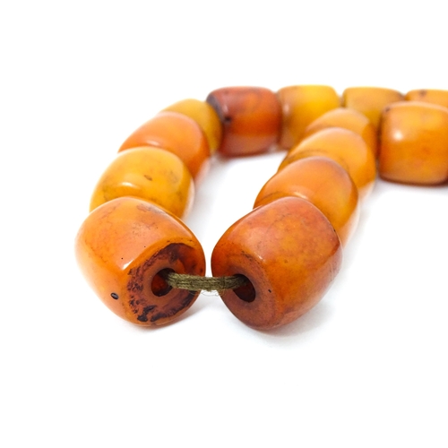 699 - A vintage bead necklace of graduated amber coloured cylindrical beads. Approx. 30