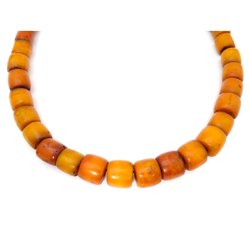 699 - A vintage bead necklace of graduated amber coloured cylindrical beads. Approx. 30