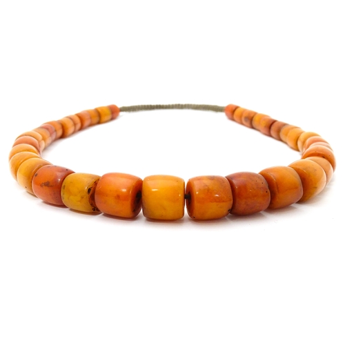 699 - A vintage bead necklace of graduated amber coloured cylindrical beads. Approx. 30