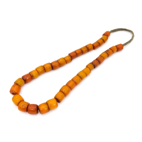 699 - A vintage bead necklace of graduated amber coloured cylindrical beads. Approx. 30