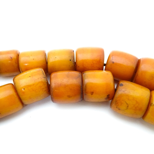 699 - A vintage bead necklace of graduated amber coloured cylindrical beads. Approx. 30