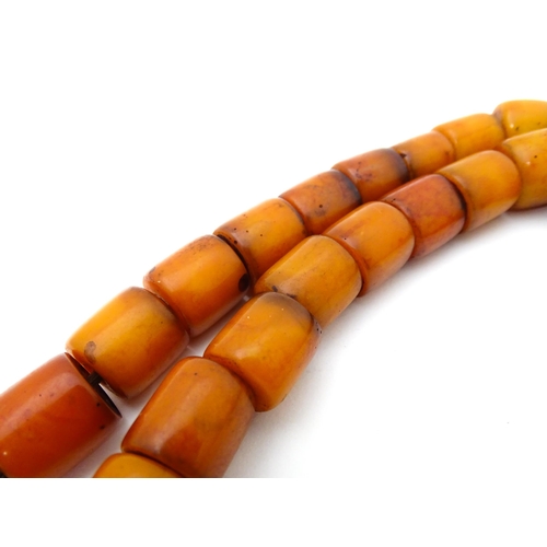 699 - A vintage bead necklace of graduated amber coloured cylindrical beads. Approx. 30