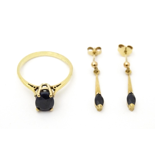 703 - A 9ct gold ring set with central sapphire. Together with matching earrings. Ring size approx. N