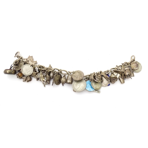 706 - A silver charm bracelet set with a quantity of assorted silver, white metal and silver plate charms,... 