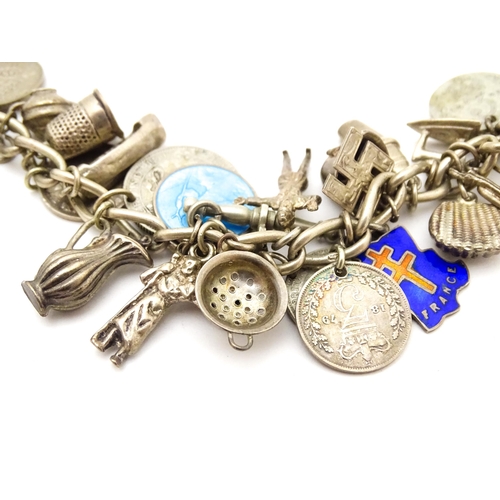 706 - A silver charm bracelet set with a quantity of assorted silver, white metal and silver plate charms,... 