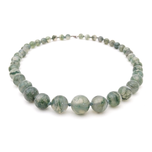 707 - A moss agate bead necklace. Approx. 22