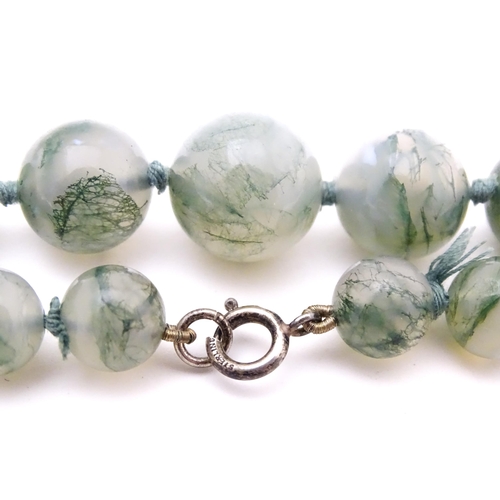 707 - A moss agate bead necklace. Approx. 22