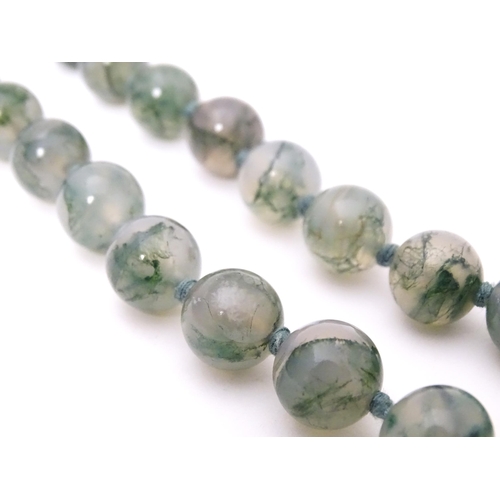 707 - A moss agate bead necklace. Approx. 22