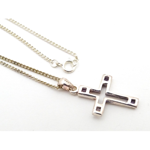 710 - Six assorted cross / cruciform pendants on chains, to include some silver examples. Largest pendant ... 